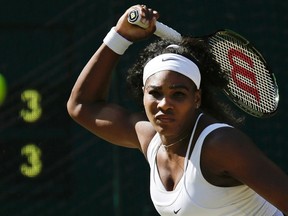 Serena Williams of the United States returns a shot to Maria Sharapova of Russia, during the women's singles semifinal match at the All England Lawn Tennis Championships in Wimbledon, London, Thursday July 9, 2015. (AP Photo/Pavel Golovkin)