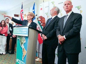 California Governor Jerry Brown (R) with Premier Kathleen Wynne (L) and Quebec Premier Phillipe Couillard answering questions at a press conference for the Climate Summit of the Americas on Wednesday July 8, 2015, in Toronto. (Veronica Henri/Toronto Sun)