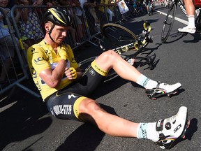 Germany's Tony Martin, wearing the overall leader's yellow jersey, holds his broken collar bone after crashing in the last stretch of the sixth stage of the Tour de France that finished in Le Havre, France, on Thursday, July 9, 2015. (Eric Feferberg/Pool via AP)