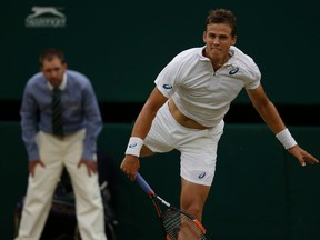 Vasek Pospisil returns a shot to Andy Murray during their singles match at in Wimbledon in London on Wednesday, July 8, 2015. (Alastair Grant/AP Photo)