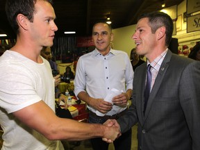 NHL player, Jonathan Toews (left) shakes hands with Winnipeg Mayor Brian Bowman, MLA Kevin Chief is in the background.  Toews announced the latest grants from the Winnipeg Foundation's Nourishing Potential Fund.  Thursday, July 09, 2015. Chris Procaylo/Winnipeg Sun/Postmedia Network