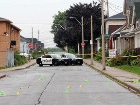 Police investigate the scene where a man was attacked by a dog on in Toronto Thursday July 9, 2015. (Nick Westoll/Toronto Sun)