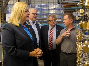 Artisan Metal Finishing president Barry Foley explains his firm?s metal coating work to visiting London-area MPs Susan Truppe, Joe Preston and Ed Holder, junior science and technology minister, on Thursday as Truppe announced a federal loan to help the company expand. (MIKE HENSEN, The London Free Press)