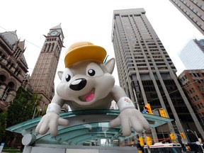 Pachi, mascot for the Pan Am Games, greets visitors at a bus stop in downtown Toronto Thursday. The city and region will hold the Games starting with today?s opening ceremony. (Julio Cortez / The Associated Press)