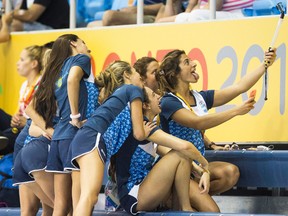 Members of the Argentine women's swim team pose for a group selfie yesterday. (Mark Blinch, Canadian Press)