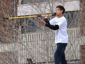 John Lappa/Sudbury Star file photo
Wendell Bondy prepares to hurl a fire pole as firefighters position an inflatable pad outside an apartment on the Lloyd Street hill on April 23.