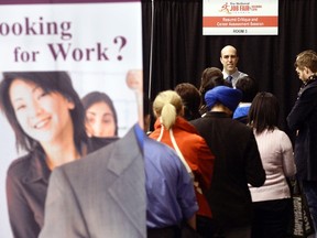 People wait in line for resume critique and career assessment sessions at the 2014 Spring National Job Fair and Training Expo in Toronto in this file photo from April 3, 2014. (REUTERS/Aaron Harris/Files)