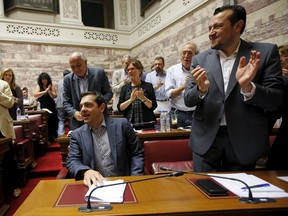 Greek Prime Minister Alexis Tsipras arrives for a session of the ruling Syriza's leftist party parliamentary group at the Parliament building in Athens, Greece July 10, 2015. (REUTERS/Jean-Paul Pelissier)