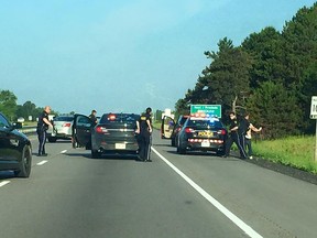 Ontario Provincial Police take a male into custody after a high-risk takedown on Hwy. 401 west of Kingston Friday morning July 10, 2015. Four teens were travelling in a vehicle that was reported stolen from Ottawa. Two males and two females were taken into police custody. Submitted Photo/The Kingston Whig-Standard/Postmedia Network