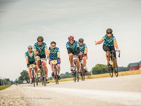Anita Trusler, right, flashes a thumbs-up sign as she rides in last year's Johnson MS Bike - Grand Bend to London fundraiser for the MS Society of Canada. Trusler, and fellow riders with Team Sparlings Propane, are back doing the trek again this year, July 25-26. Handout courtesy of George Wang Photography/Sarnia Observer/Postmedia Network