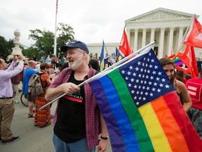 In this June 26, 2015 photo, supporters celebrate outside the U.S. Supreme Court in Washington after the court declared that same-sex couples have a right to marry anywhere in the United States. Attorney General Loretta Lynch says the government will make federal marriage benefits available to same-sex couples. AP Photo/Manuel Balce Ceneta