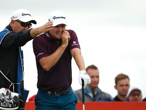Justin Rose (right) hit an elderly spectator on the head with a wayward drive during the second round at the Scottish Open on Friday, July 10, 2015. (Lee Smith/Action Images via Reuters)