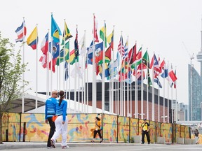 Flags of the participating countries fly in the athletes' village as the CN Tower stands in the background at the 2015 Pan American Games in Toronto on Thursday, July 9, 2015. (Darren Calabrese/THE CANADIAN PRESS)