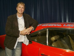 Actor John Schneider poses with the "General Lee" car from "The Dukes of Hazard" televison show he starred in.