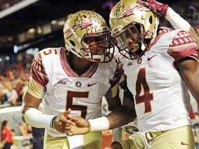 Florida State Seminoles quarterback Jameis Winston (left) celebrates with running back Dalvin Cook (right) after Cook scored a touchdown against the Miami Hurricanes during the second half at Sun Life Stadium. FSU won 30-26. Steve Mitchell-USA TODAY Sports