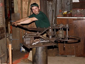 Cody Mailhiot bends a piece of steel using a hossfelt bender at VanTuyl and Fairbank Hardware Friday. Mailhiot, who has worked at the Petrolia landmark for the last three years, helped the store celebrate its 150th anniversary. (CHRIS O'GORMAN, The Observer)