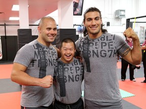 UFC fighters Chad Laprise, left  and Elias Theodorou train Special Olympic athleteKai Freelands of Belleville  at the Haybusa Academy in on Friday July 10 2015. Ian MacAlpine/The Kingston Whig-Standard/Postmedia Network