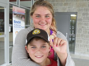 Morgan Salter, 12, is being credited for using CPR to save her brother Cooper, 10, when he started choking on a one dollar coin. The siblings are photographed in Kingston, Ont. on Thursday July 9, 2015. Elliot Ferguson/Kingston Whig-Standard/Postmedia Network
