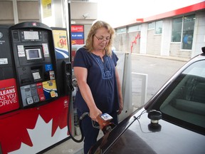 Cheri Nadeau fills her gas tank in London, Ont. (Free Press file photo)