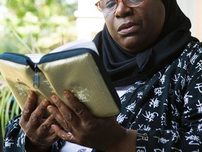 Michelle Walrond reads the Quran at her Ottawa home. She testified before the Senate committee on National Security.  Friday July 10, 2015. 
Errol McGihon/Ottawa Sun