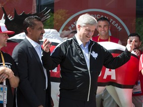 Canadian Prime Minister Stephen Harper, (R), stands with federal Minister for Sport Bal Gosal, as he visits Canadian athletes at the Pan Am Games athletes' village in Toronto on Friday. (CRAIG ROBERTSON, Tornto Sun)