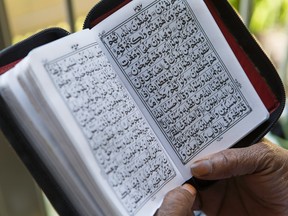 Michelle Walrond reads the Quran at her Ottawa home. She testified before the Senate committee on National Security.  Friday July 10, 2015. 
Errol McGihon/Ottawa Sun