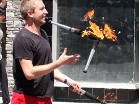 David Graham of The Red Trouser Show from New Hampshire  perform on Princess Street during the Kingston Buskers Rendezvous on Friday July 10 2015. Ian MacAlpine/The Kingston Whig-Standard/Postmedia Network