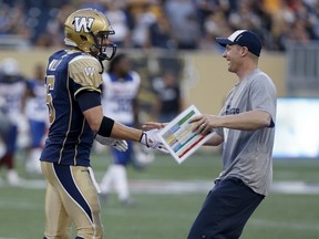 Winnipeg Blue Bombers' quarterback Drew Willy (5) celebrates with head coach Mike O'Shea after defeating the Montreal Alouettes' during CFL action in Winnipeg, Manitoba July 10, 2015. REUTERS/Trevor Hagan