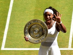 Serena Williams of the U.S.A celebrates with the trophy after winning her Women's Final match against Garbine Muguruza of Spain at the Wimbledon Tennis Championships in London, July 11, 2015.   REUTERS/Dominic Lipinski