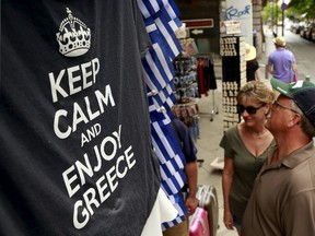 T-shirts are seen on display in a shop in Athens, Greece July 11, 2015. Greek Prime Minister Alexis Tsipras won backing from lawmakers on Saturday for painful reforms but it remained unclear whether it would be enough to secure a bailout from German and other euro zone ministers meeting in Brussels. REUTERS/Cathal McNaughton