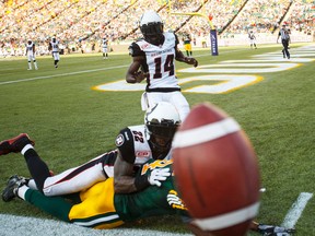 Edmonton's Adarius Bowman (4) is tackled by Ottawa's Brandon McDonald (22) during first half CFL action between the Ottawa Redblacks and the Edmonton Eskimos at Commonwealth Stadium in Edmonton, Alta.. on Thursday July 9, 2015. Ian Kucerak/Edmonton Sun/Postmedia Network