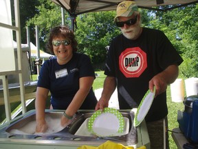 Transition to Less Waste volunteers Sherri Wiebe and John Joosse wash dishes at the Canterbury Folk Festival. (HEATHER RIVERS/Sentinel-Review file photo)