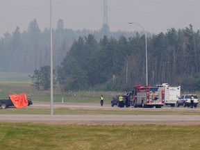 Emergency crews work at the scene of a single vehicle fatal accident along Anthony Henday Drive near Stony Plain Road, in Edmonton Alta. on Saturday July 11, 2015. David Bloom/Edmonton Sun/Postmedia Network