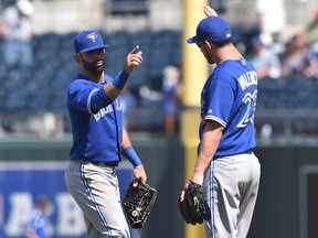 Toronto Blue Jays outfielders Jose Bautista, left, and third basemen Danny Valencia celebrate after beating the Kansas City Royals at Kauffman Stadium. Despite playing in Saturday's game, Bautista will miss the MLB all-star game due to injury. (Peter G. Aiken-USA TODAY Sports)