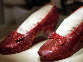 This April 10, 1996 file photo shows one of the four pairs of ruby slippers worn by Judy Garland in the 1939 film "The Wizard of Oz" on display during a media tour of the "America's Smithsonian" traveling exhibition in Kansas City, Mo. An anonymous donor has offered a $1 million reward for credible information leading to a pair of the sequined shoes which was stolen from a museum in her Minnesota hometown, Grand Rapids. The 10-year anniversary of the theft is in August 2015. (AP Photo/Ed Zurga)
