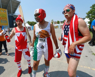 Three stereotypical characters mug for the cameras at Pan Am Park at Exhibition Centre on Day One of the Games on Saturday July 11, 2015. Jack Boland/Toronto Sun/Postmedia Network