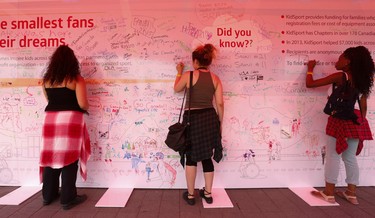 Spectators and visitors sign a message board at Pan Am Park at Exhibition Centre on Day One of the Games on Saturday July 11, 2015. Jack Boland/Toronto Sun/Postmedia Network