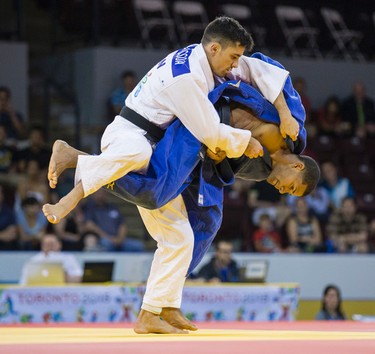Sergio Pessoa (Canada, in white outfit) and Abel Montero (Dominician Republic) during the Judo Men's 1/8th final Contest 3 in the under 60kg category during the Pan Am Games  at the Mississauga Sports Centre in Mississauga, Ont. on Saturday July 11, 2015. Pessoa won the round.  Ernest Doroszuk/Toronto Sun/Postmedia Network