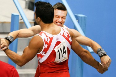 Canadian teammates  René COURNOYER (L)and Hugh SMITH  celebrate during the Mens Gymnastics Artistic Competition on Saturday July 11, 2015. Veronica Henri/Toronto Sun/Postmedia Network