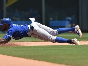Jose Reyes of the Toronto Blue Jays dives into second base with one of his three stolen bases against the Kansas City Royals on July 11, 2015, at Kauffman Stadium in Kansas City. (PETER G. AIKEN/USA TODAY Sports)