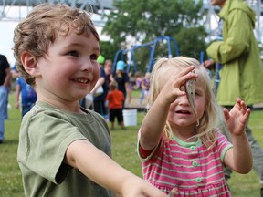 Two-year-old cousins Landyn Moore and Sara-Beth Manning show off some of the gobies they hauled in Saturday in the annual Bluewater Anglers' Family Fun Derby. About 175 people took part in the goby fish-off, an organizer said. (Tyler Kula, The Observer)
