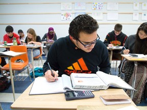 Moayyad Al-Omari and others attend Daniel Noordam's grade 11 summer school math class at H.B. Beal Secondary School in London, Ont. on Thursday July 9, 2015. (DEREK RUTTAN, The London Free Press)