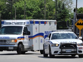 Police and paramedics are pictured in Barrie, Ont., in this file photo. A 22-year-old Barrie man is facing nine charges after allegedly ramming three police cruisers and injuring a police officer during a chase. (Mark Wanzel/The Barrie Examiner/Postmedia Network)