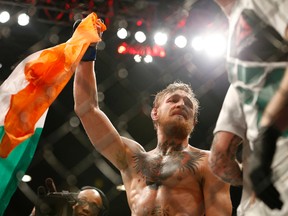 Conor McGregor celebrates after defeating Chad Mendes in their interim featherweight title MMA bout at UFC 189 on July 11, 2015, in Las Vegas. (AP Photo/John Locher)