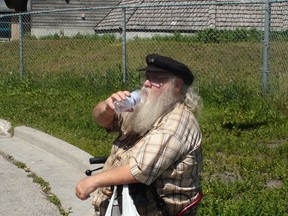 Homeless Winnipegger Tom George enjoys free water from Devoted to You Street Ministries Sunday. The ministry handed out about 500 free bottles of water to those in the downtown that day as a heat warning of high humidex levels was in effect. (JIM BENDER/Winnipeg Sun)