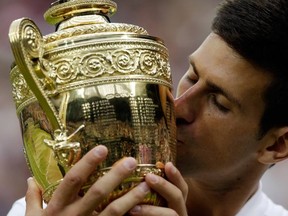 Novak Djokovic of Serbia kisses the trophy after winning the men's singles final against Roger Federer of Switzerland at the All England Lawn Tennis Championships in Wimbledon, London, Sunday July 12, 2015. 

(AP Photo/Alastair Grant)