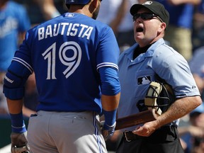 Jose Bautista of the Blue Jays argues with plate umpire Jerry Meals after being ejected during the eighth inning yesterday. “I don’t know why he threw me out,” Bautista said. (ORLIN WAGNER/AP)
