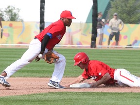 Canada’s Peter Orr slides safely into second base as Ronald Luna of Columbia bobbles the ball yesterday at President’s Choice Ajax Park. (Veronica Henri/Toronto Sun)