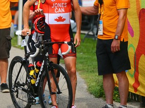 Canadian triathlete Kyle Jones  is consoled after having to pull out of the event on Sunday. (Dave Abel)