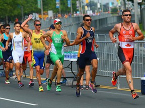 Canadian Andrew Yorke and the rest of the pack in the men’s triathlon run past a labyrinth of fences set up along Lakeshore Blvd., yesterday — a series of barriers that, according to our Steve Simmons, makes the simple task of getting from Point A to Point B an unnecessarily long endeavour. (DAVE ABEL, Toronto Sun)